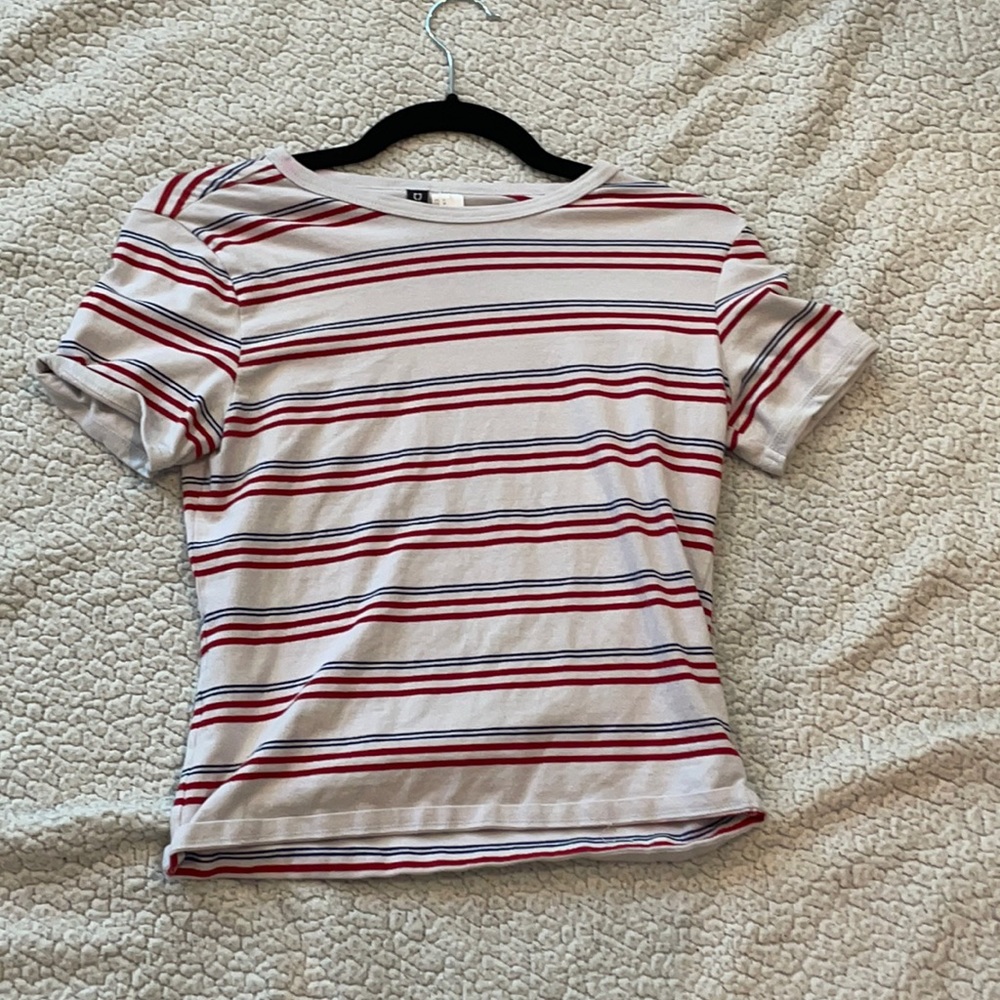 Red, white, and blue striped shirt.